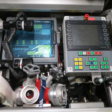 Rafmagnstafla og aðgerðaskjár í vinstri fremri hliðarskáp